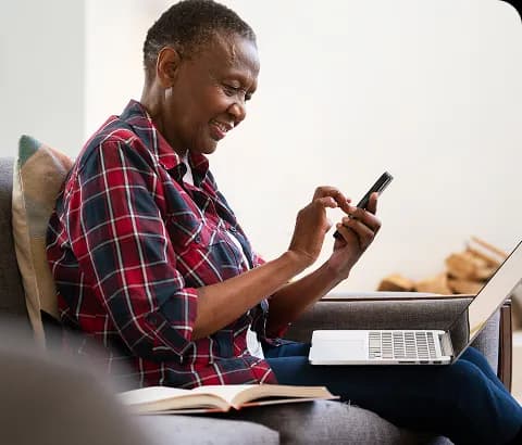 Person using laptop and phone